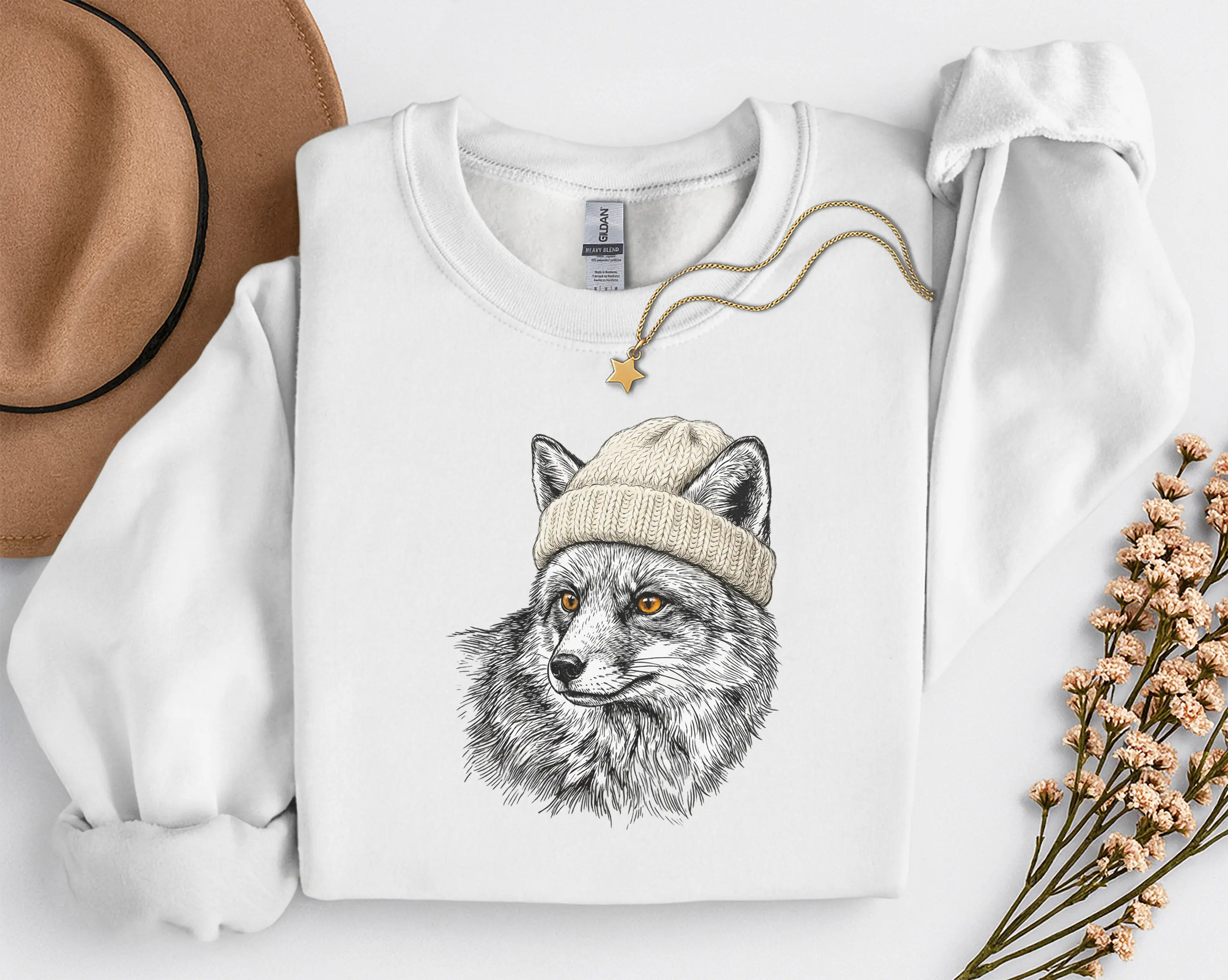 sweat-renard-bonnet-blanc Sweat blanc avec illustration d'un renard en bonnet, photo à plat avec chapeau et collier étoile